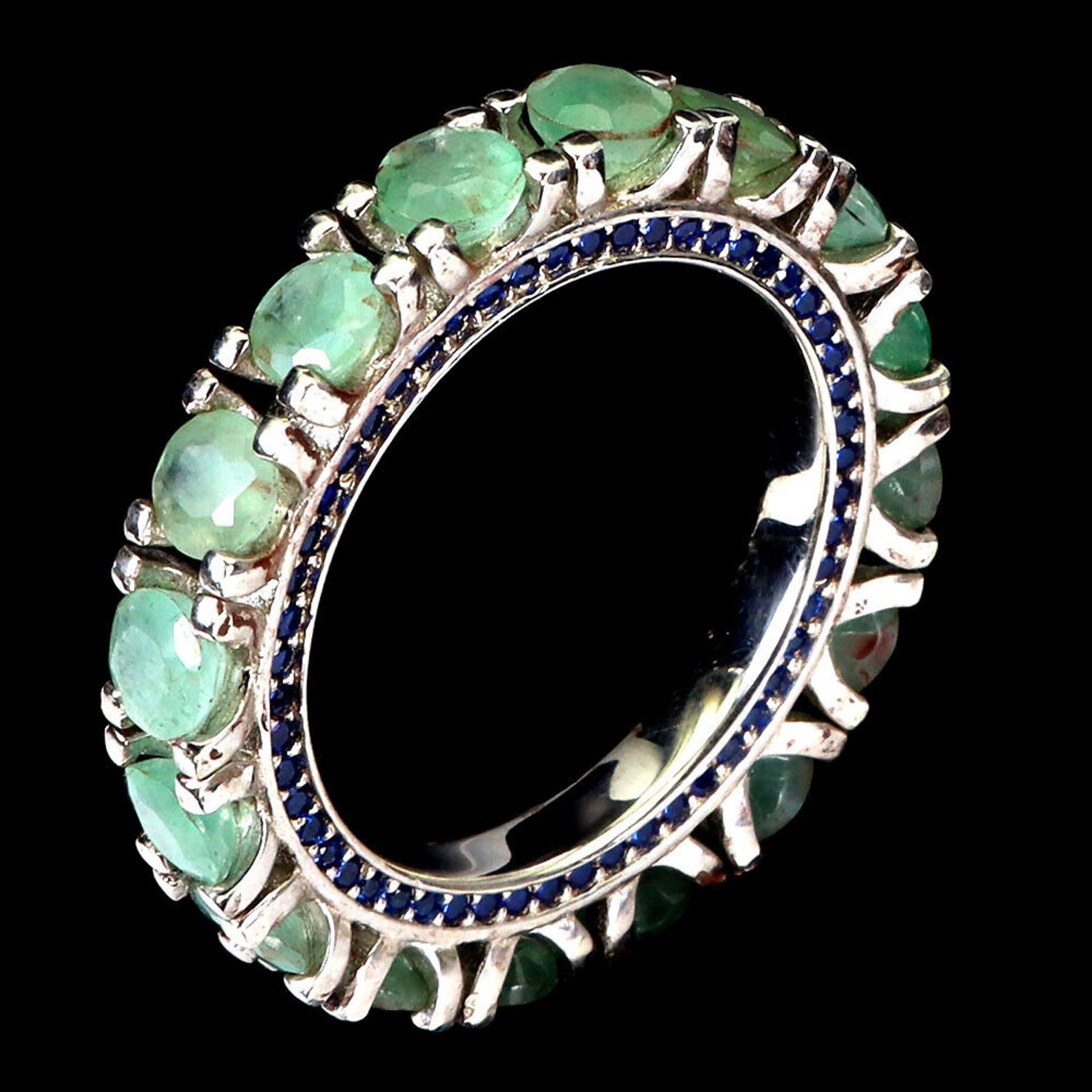 A 925 silver full eternity ring set with emeralds and sapphire set shank, ring size O. - Image 2 of 3