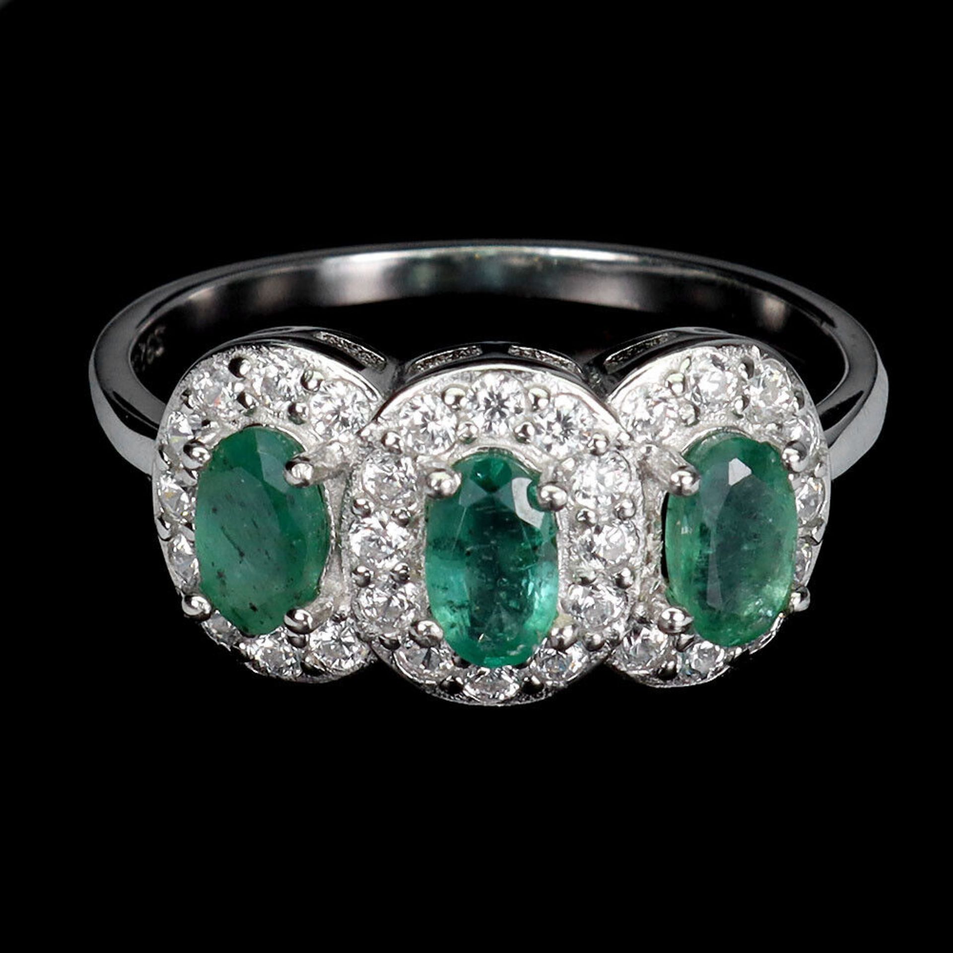 A 925 silver triple cluster ring set with oval cut emeralds and white stones, ring size N.5.
