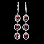 A pair of 925 silver drop earrings set with oval cut rubies and white stones, L. 5.2cm.