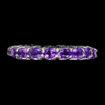 A 925 silver full eternity ring set with oval cut amethysts, ring size N.