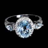 A 925 silver ring set with oval cut blue topaz and white stones, ring size 6.5.