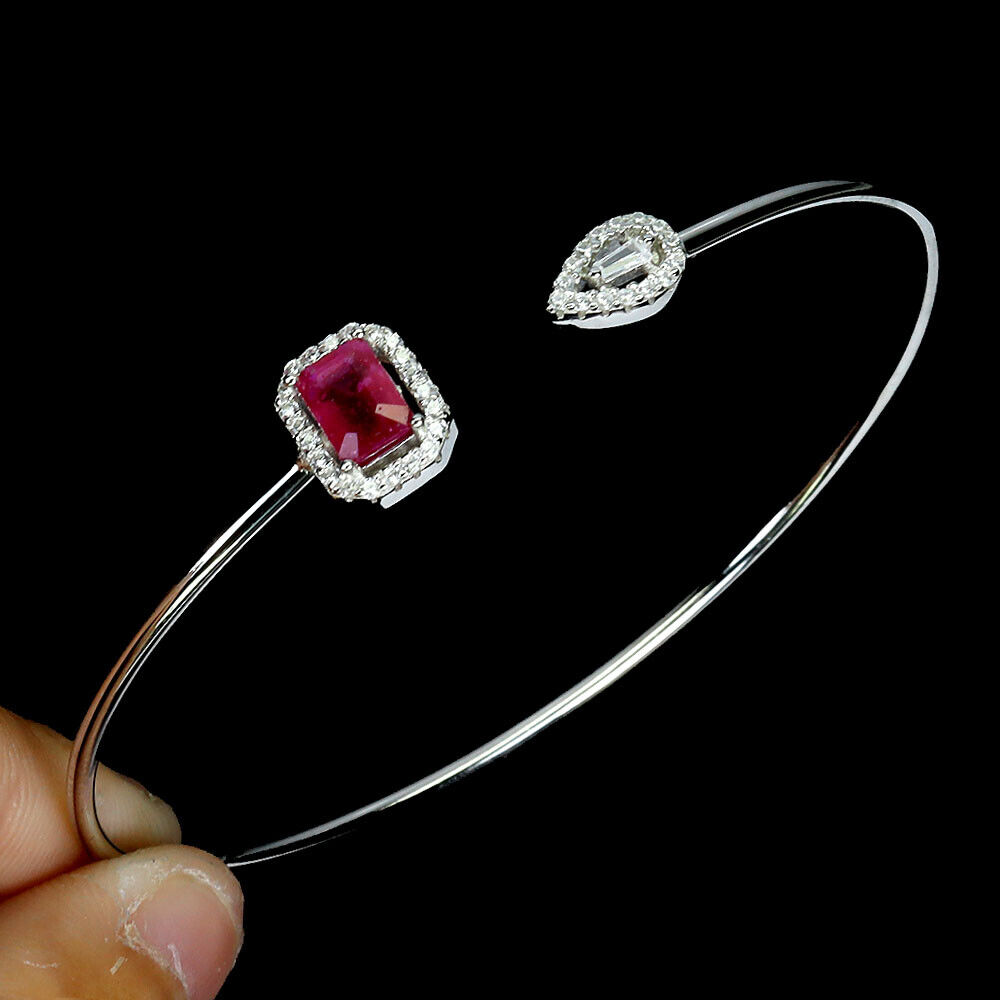 A 925 silver bangle set with an emerald cut ruby and white stones, 5.5 x 4.5cm. - Image 3 of 3