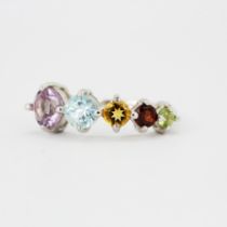 A 925 silver ring set with peridots, garnets, blue topaz, citrines and amethysts, ring size N.
