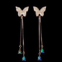 A pair of rose gold on 925 silver butterfly shaped drop earrings set with opals, L. 6cm.