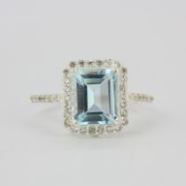 A 925 silver ring set with an emerald cut blue topaz, (Q).