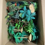 A box containing plastic trees etc. possibly for a diorama.