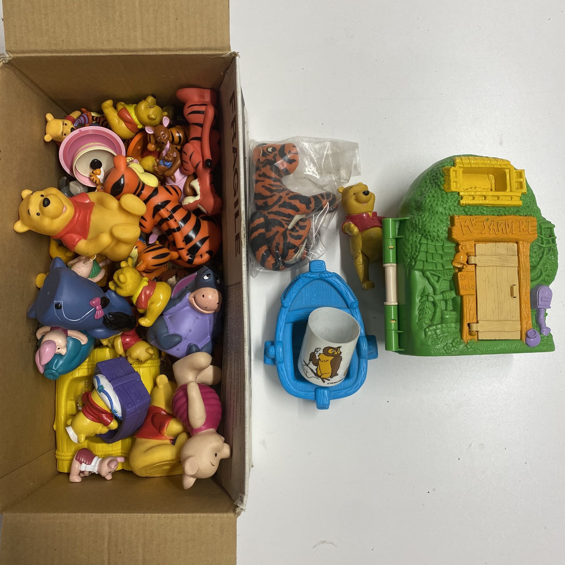 Various Winnie the Pooh Disney figures.