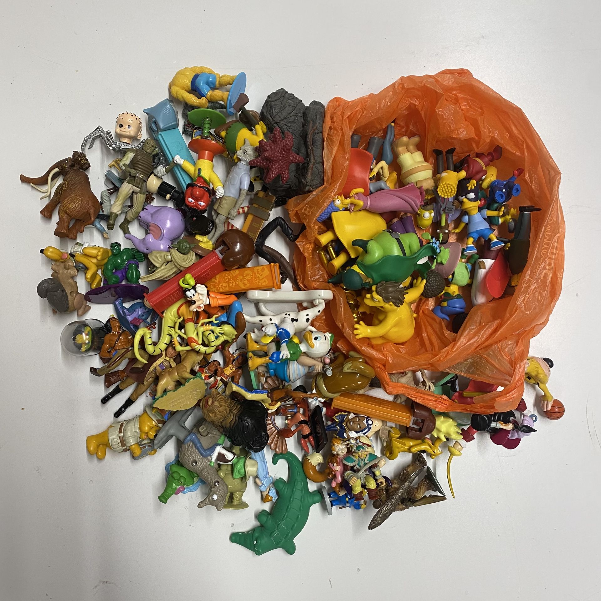 A mixed box of mostly Disney toys.