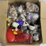 A quantity of happy meal Snoopy toys.