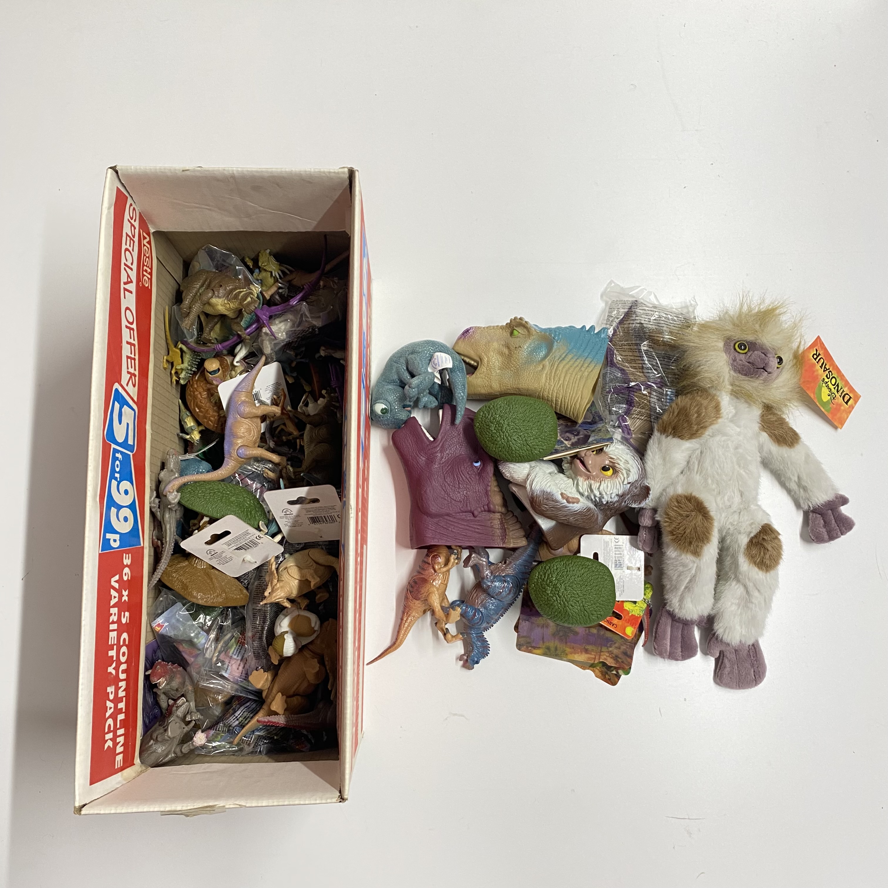 A box of various dinosaur toys.