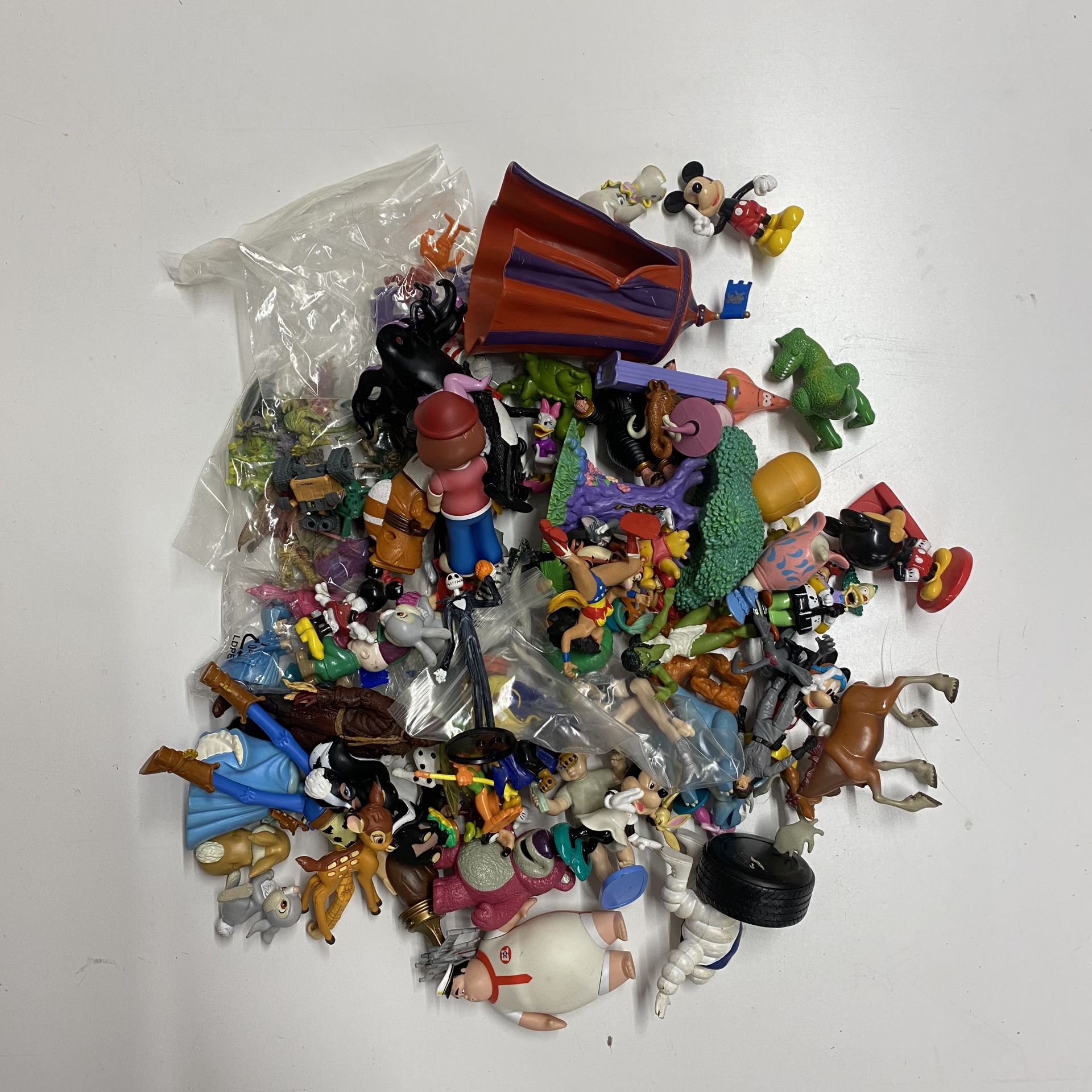 A box containing a large quantity of various Disney characters and others.