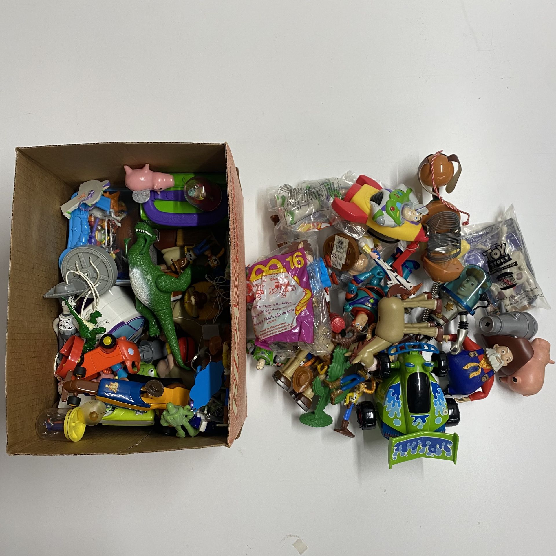 A box containing Disney Toy Story figures etc.