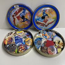 Two tins of various Disney badges.