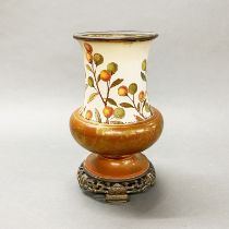 A continental painted and gilt pottery vase, mounted on a bronze base with gilt metal liner, H.