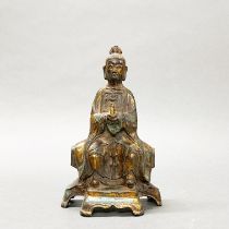 A Chinese gilt bronze figure of a seated Deity, H. 24cm.