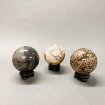 A group of three large polished hardstone balls, Dia. 10cm.