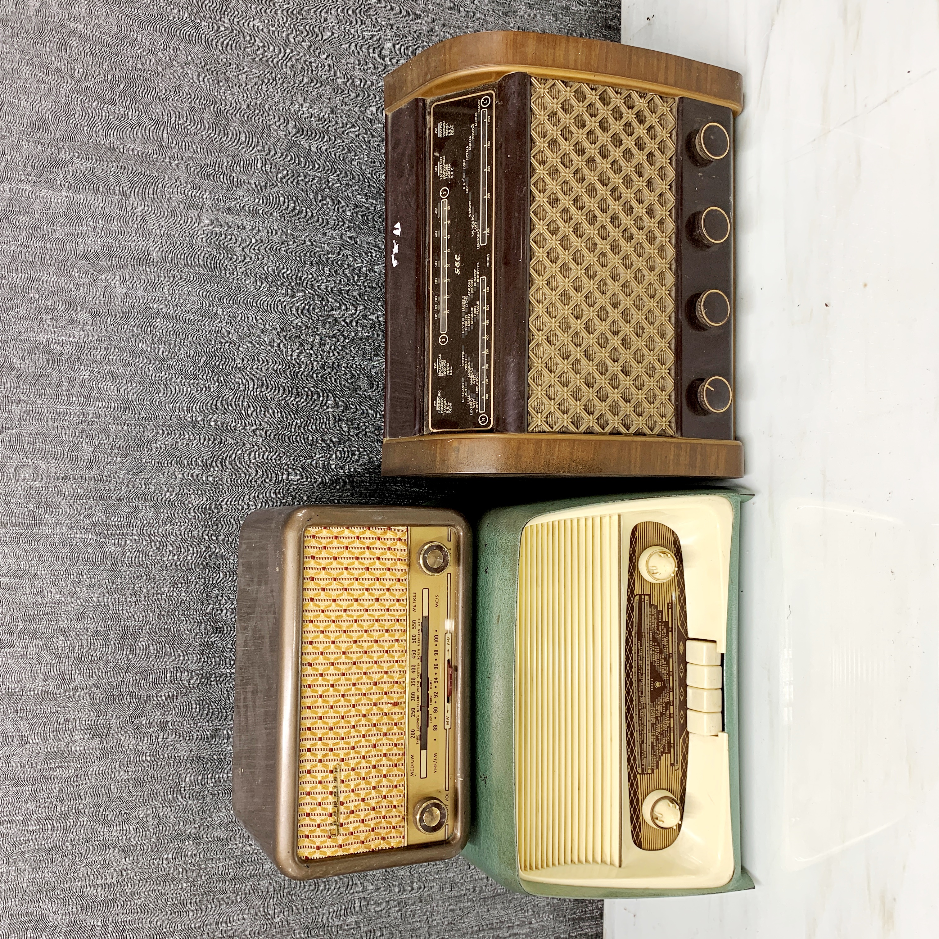 Three vintage radios, including a Champion.