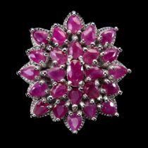 A large 925 silver cluster ring set with rubies, ring size O.5.