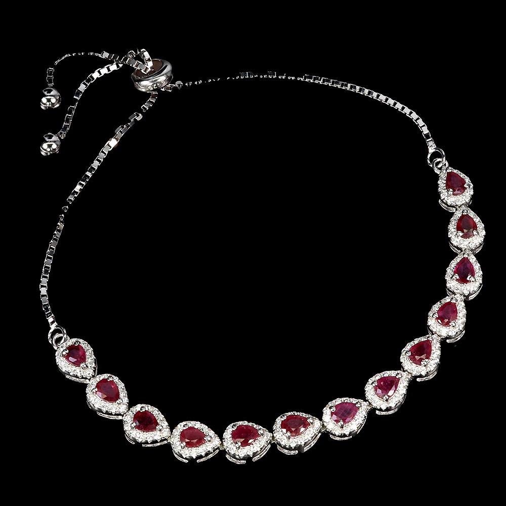 A 925 silver adjustable bracelet set with pear cut rubies and white stones.