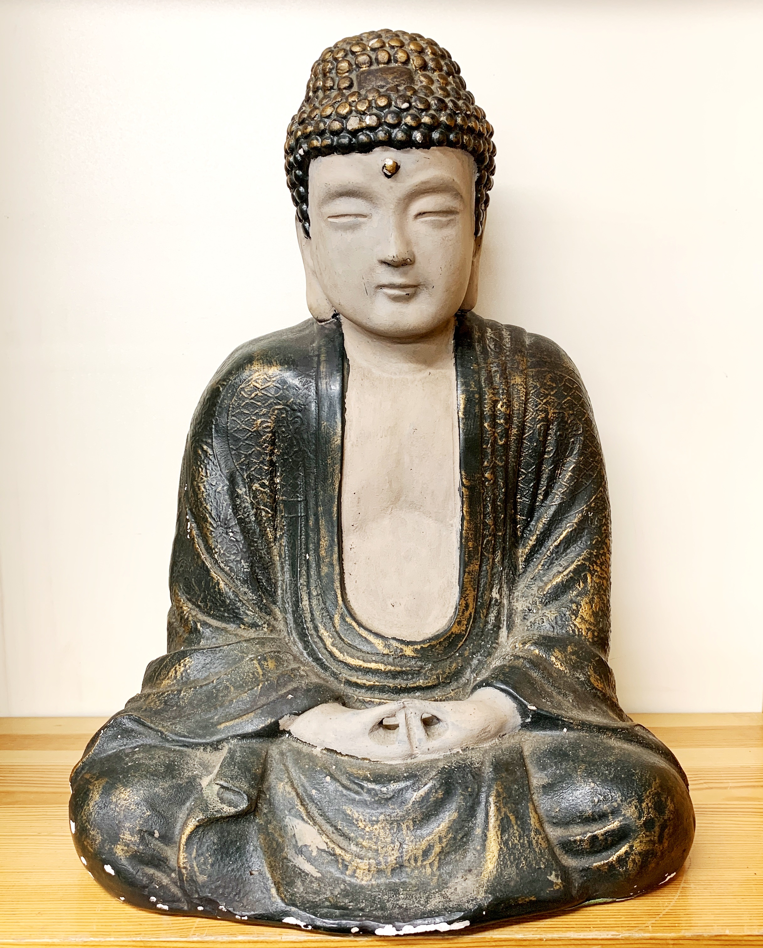 A mid 20thC Chinese painted terracotta figure of a seated Buddha, H. 45cm.