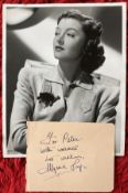 Myrna Loy signed autograph album page to Peter with unsigned vintage MGM 10 x 8 inch b/w photo. Good