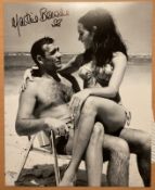 James Bond Martine Beswick signed 10 x 8 inch b/w photo on beach sitting on Sean Connery's lap. Good