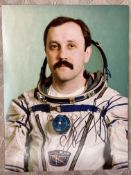 Cosmonaut Yuri Usachev Portrait signed 10 x 8 colour photo in Space Suit. Astronaut. Good condition.