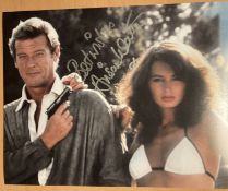 James Bond Alison Worth signed 10 x 8 inch colour photo with Roger Moore. Good condition. All