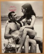 James Bond Martine Beswick signed 10 x 8 inch b/w photo on beach sitting on Sean Connery's lap. With
