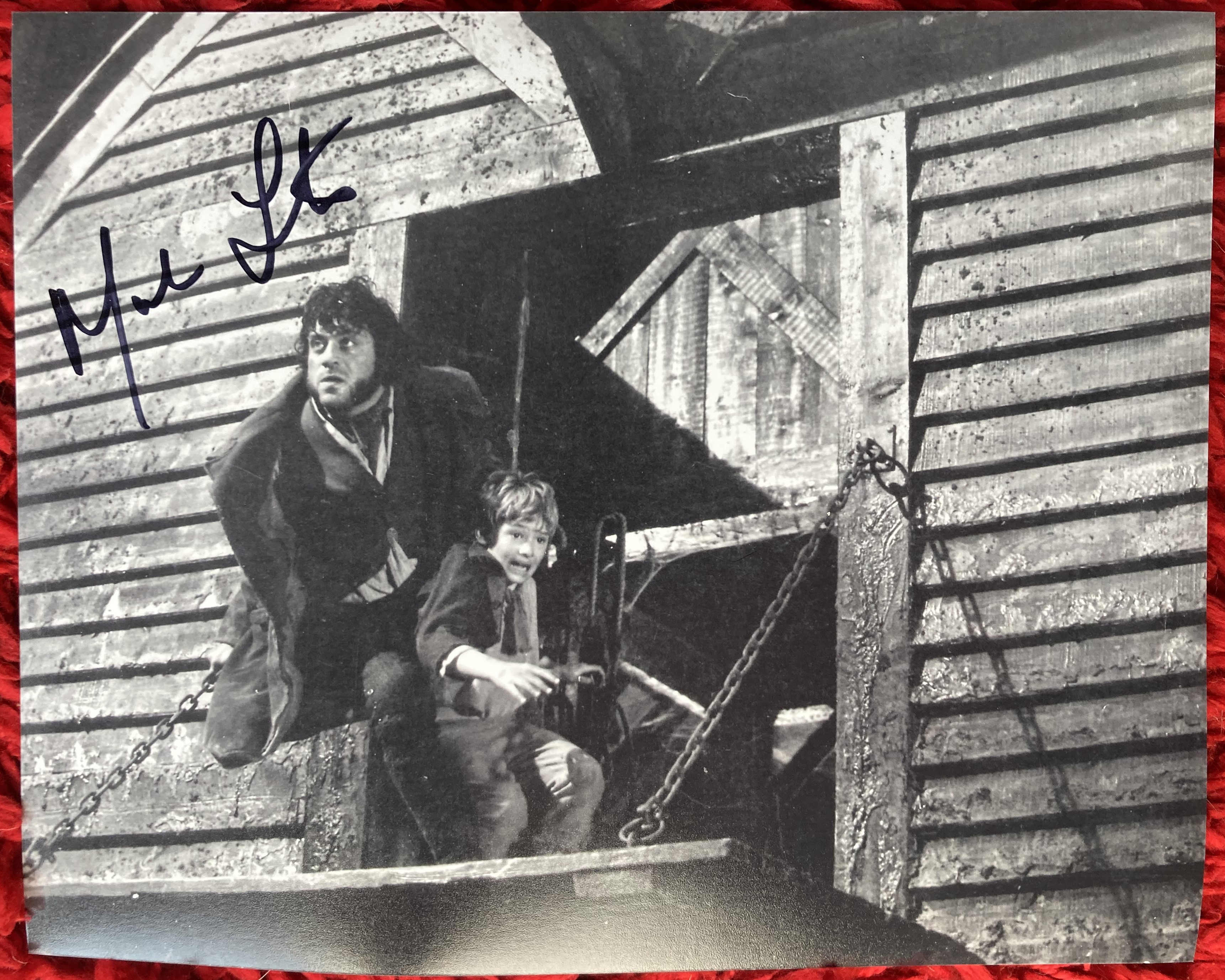 Mark Lester signed 10 x 8 inch b/w Oliver photo, nice image with Oliver Reed. Good condition. All