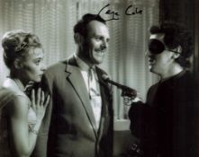 George Cole signed 10 x 8 inch b w photo in mask holding a gun to Terry Thomas. Good condition.