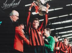 Football Tony Book signed 16x12 colour photo pictured lifting the FA Cup while captain of Manchester