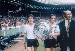 Arthur Albiston signed 12x8 colour photo pictured parading the Charity shield during his playing