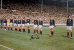 Denis Law signed 12x8 colour photo pictured lining up with his Scotland team mates before a match