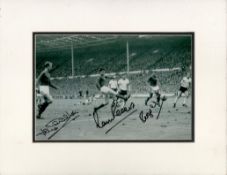 Jack Charlton, Martin Peters and Roger Hunt signed Black and White Photo Mounted to an overall