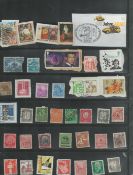 38 used Stamps in a black holder James Bond in Goldeneye, Dorothy Hodgkin, & various German