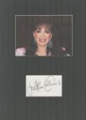 Jackie Collins, 1937-2015, Novelist Signed Card With 11x15 Mounted Photo.. Good condition. All