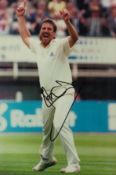 Ian Botham signed 12x8 inch colour photo pictured in action for England. Good condition. All