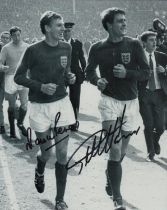 Martin Peters and Geoff Hurst signed 10x8 inch black and white photo pictured celebrating after