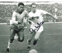 Ray Wilson signed 10x8 inch vintage black and white photo pictured in action for England against