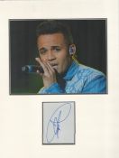 Aston Merrygold (JLS) signature piece in autograph presentation. Mounted with photograph to