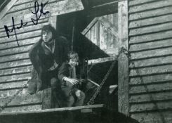 Mark Lester signed 10 x 8 inch b/w Oliver photo, nice image with Oliver Reed. Good condition. All
