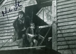 Mark Lester signed 10 x 8 inch b/w Oliver photo, nice image with Oliver Reed. Good condition. All