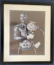 Evander Holyfield signed 20x16 mounted and framed black and white photo. Good condition. All