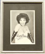 Shirley Bassey Signed black and white photo, housed in a silver effect frame measuring 11 x 9 inches