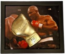 Mike Tyson signed Gold Boxing Glove displayed on a colour photo of Mike Tyson in action in a frame