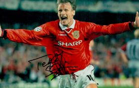 Teddy Sheringham signed 12x8 inch colour photo pictured celebrating after scoring in the Champions