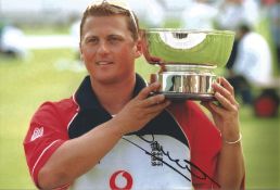 Darren Gough signed 12x8 inch colour photo pictured while on England duty. Good condition. All