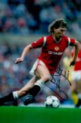 Bryan Robson signed 12x8 inch colour photo pictured in action for Manchester United. Good condition.