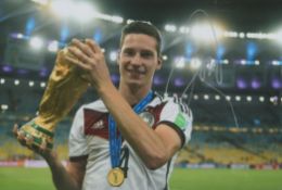 Football Julian Draxler signed 12x8 colour photograph pictured holding the 2014 FIFA World Cup for